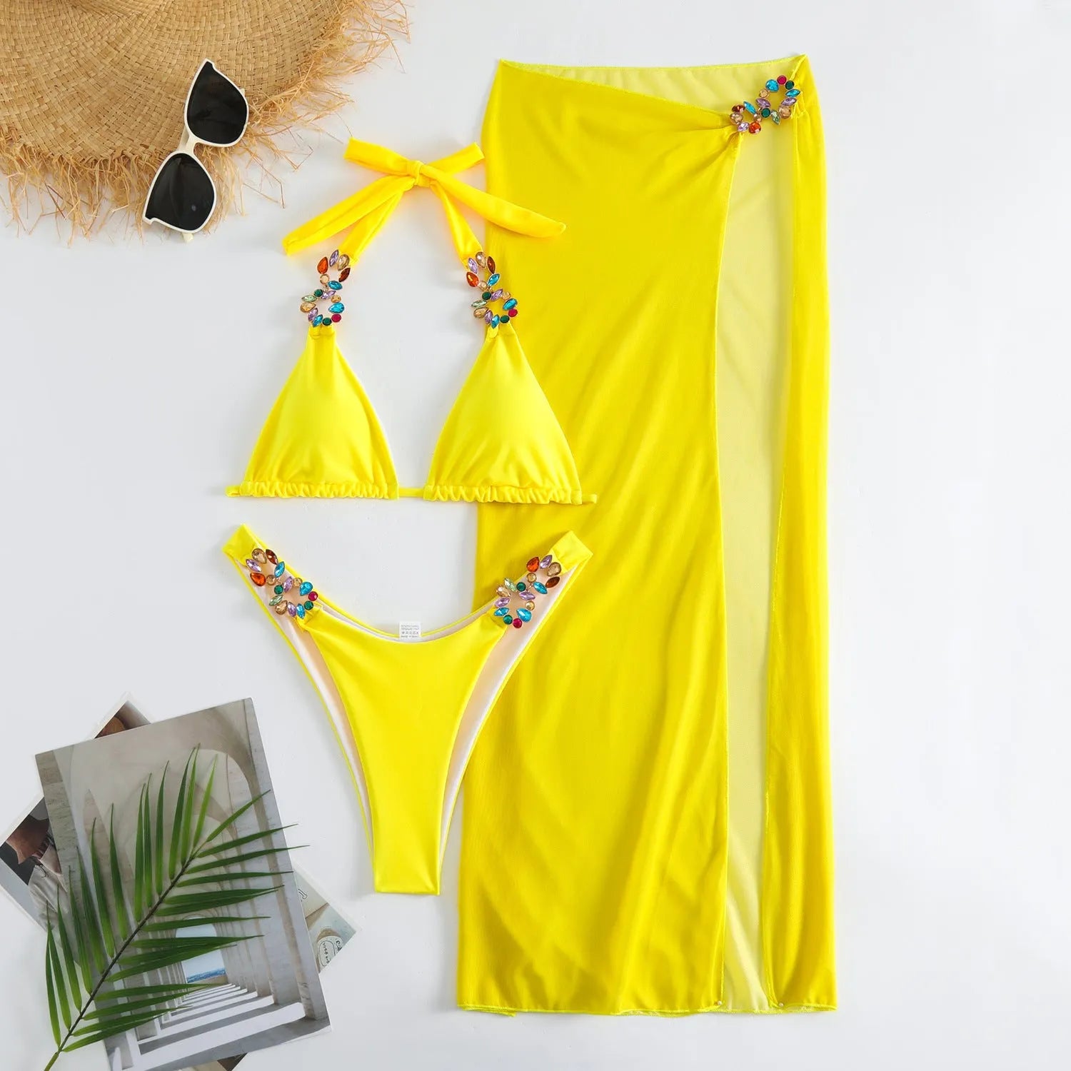 Women's three-piece swimsuit set with bikini top, pants, and matching skirt in solid colour