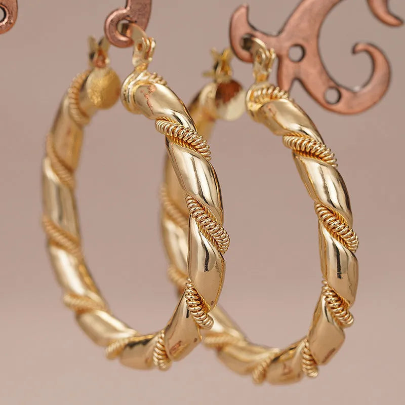 Geometric ring-shaped copper ear clips for women in a polished golden finish.