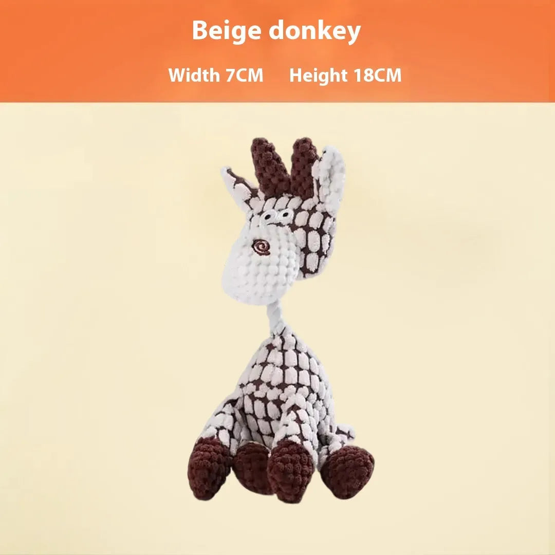 Assorted plush dog toys including a pink-gray donkey, a beige donkey, a blue elephant, and yellow ducks in three sizes.