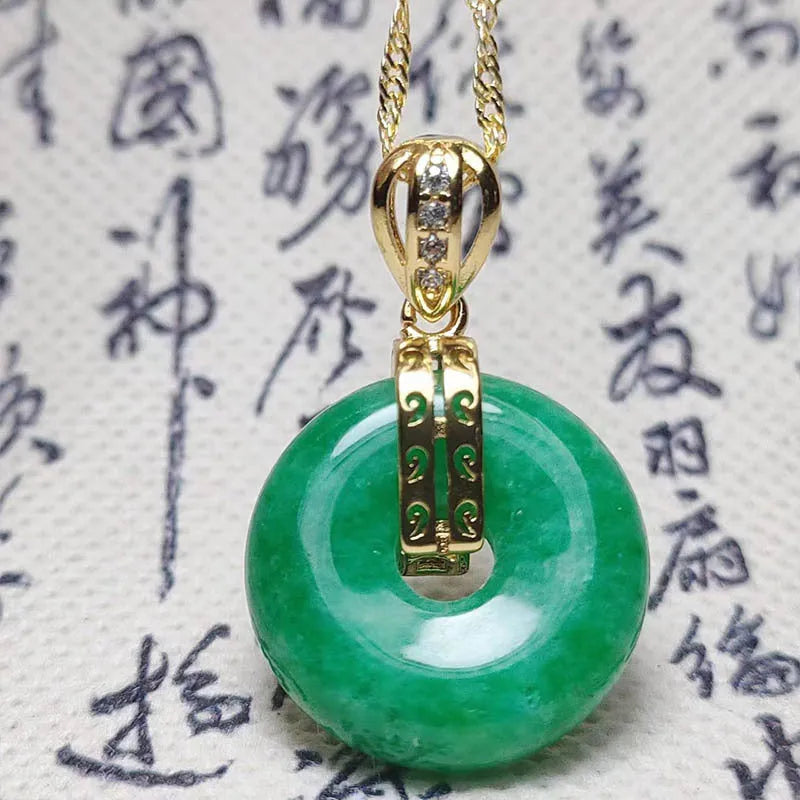 Vacuum electroplated emerald green jade pendant in safety buckle shape on white background