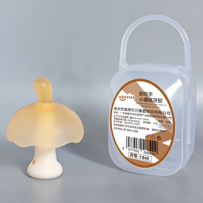 Small pink latex mushroom gum inside a transparent storage box with a thin silver chain.