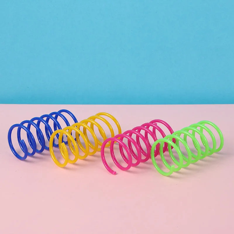 Plastic cat spring toys in mixed colours showing 5.5cm length and 2cm diameter measurements