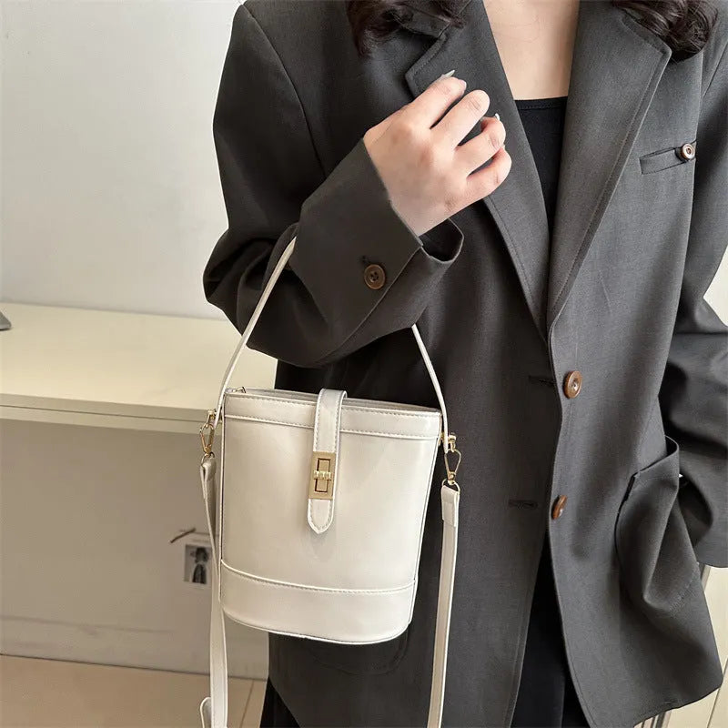 Women's one shoulder crossbody bag bucket shape in PU leather, available in black, brown, khaki, white. Width 19cm height 18.5cm.