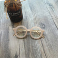 Retro round frame anti blue light glasses in multiple colours on a plain background.