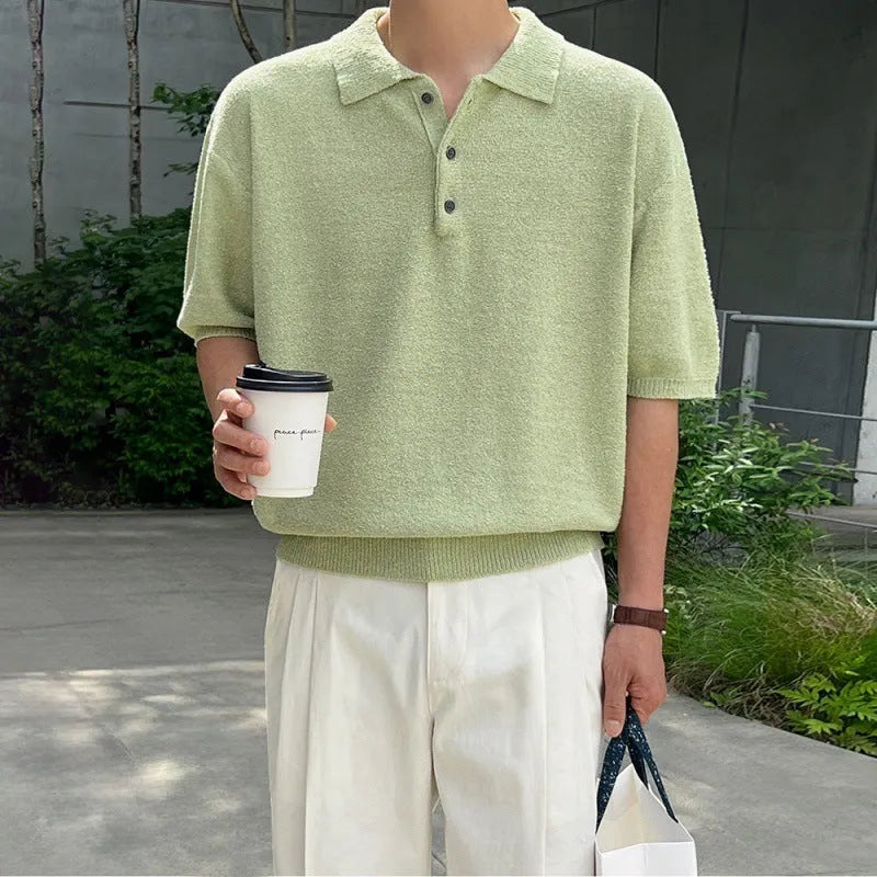 Men's caramel coloured retro knitted polo shirt with short sleeves and an asymmetrical design laid flat.