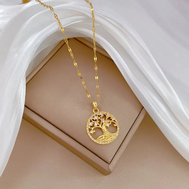 Gold-plated cross necklace with a mother-of-pearl centre and inlaid rhinestones on a lip chain.