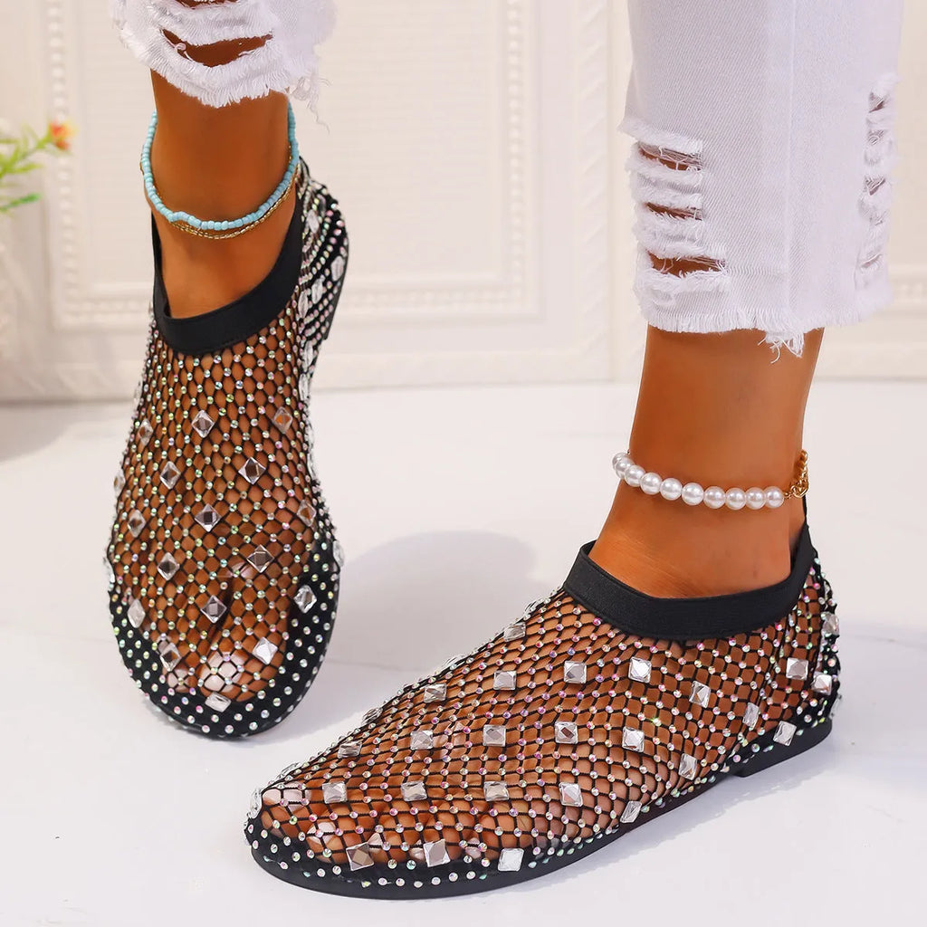 Women's white and colourful mesh flat sandals with rhinestone decoration and a round toe.