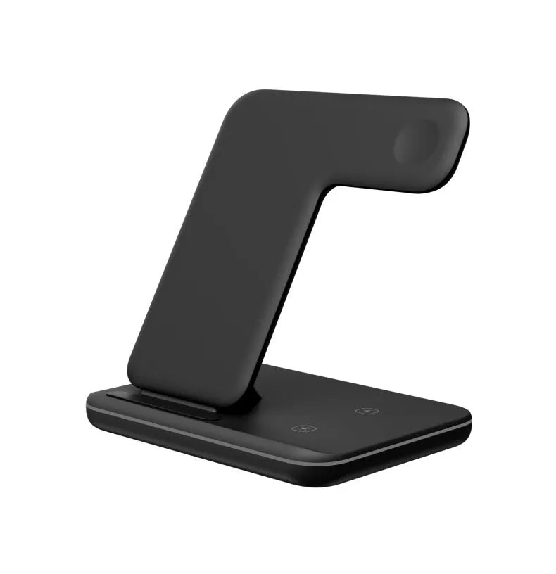 White three-in-one wireless charging stand for mobile phone, smartwatch, and headset on a desk.