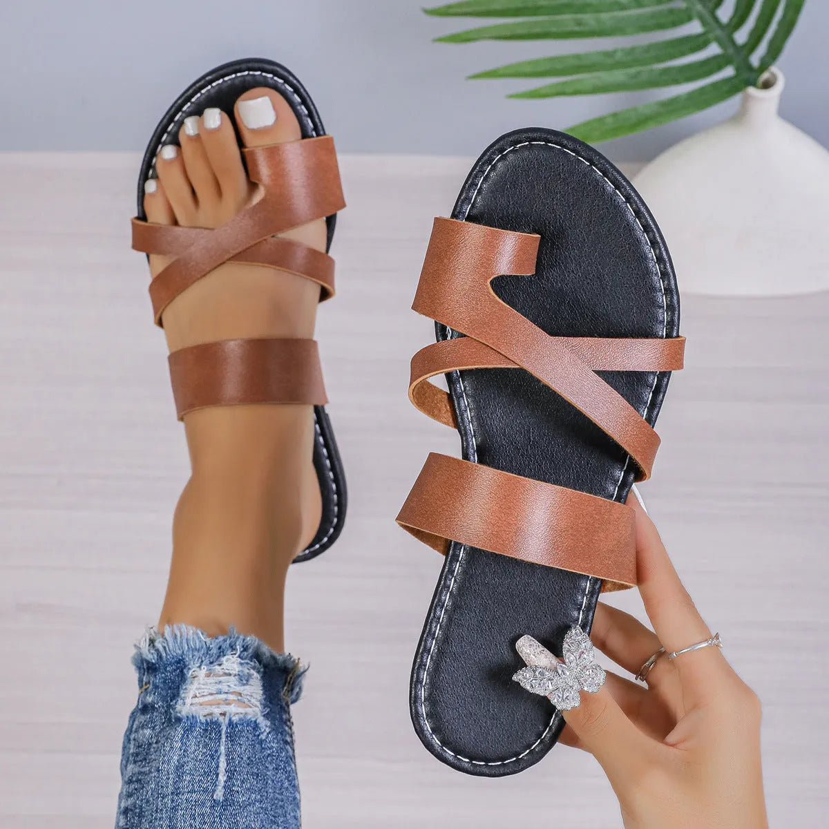 Black casual beach slipper with hollow-out design and rubber sole.