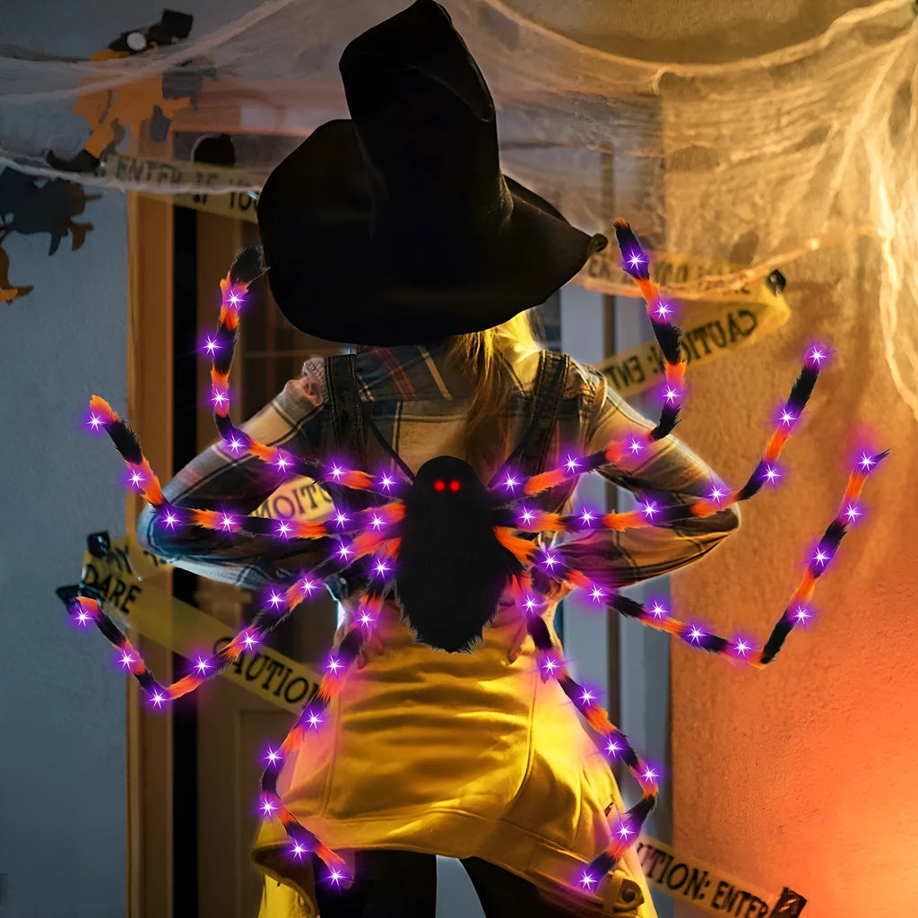 Orange Halloween spider backpack with purple LED lights on plush sugar bag material.