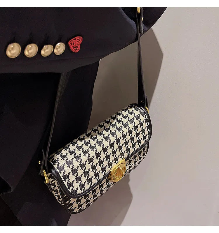 Women's houndstooth canvas baguette shoulder bag with adjustable strap on model