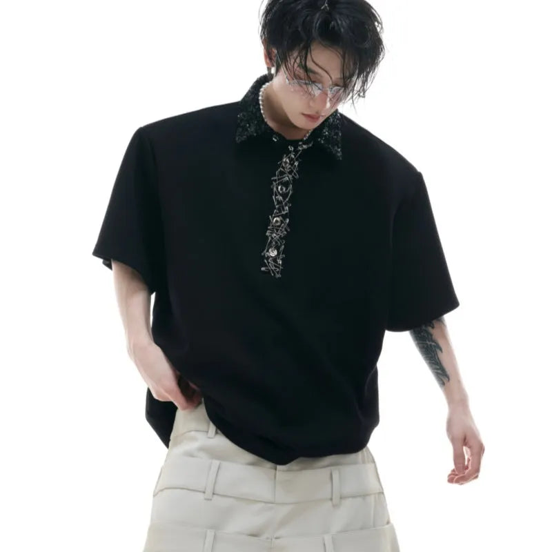 Men's black loose-fit polo shirt with front embroidery and sequin detail on a square collar.
