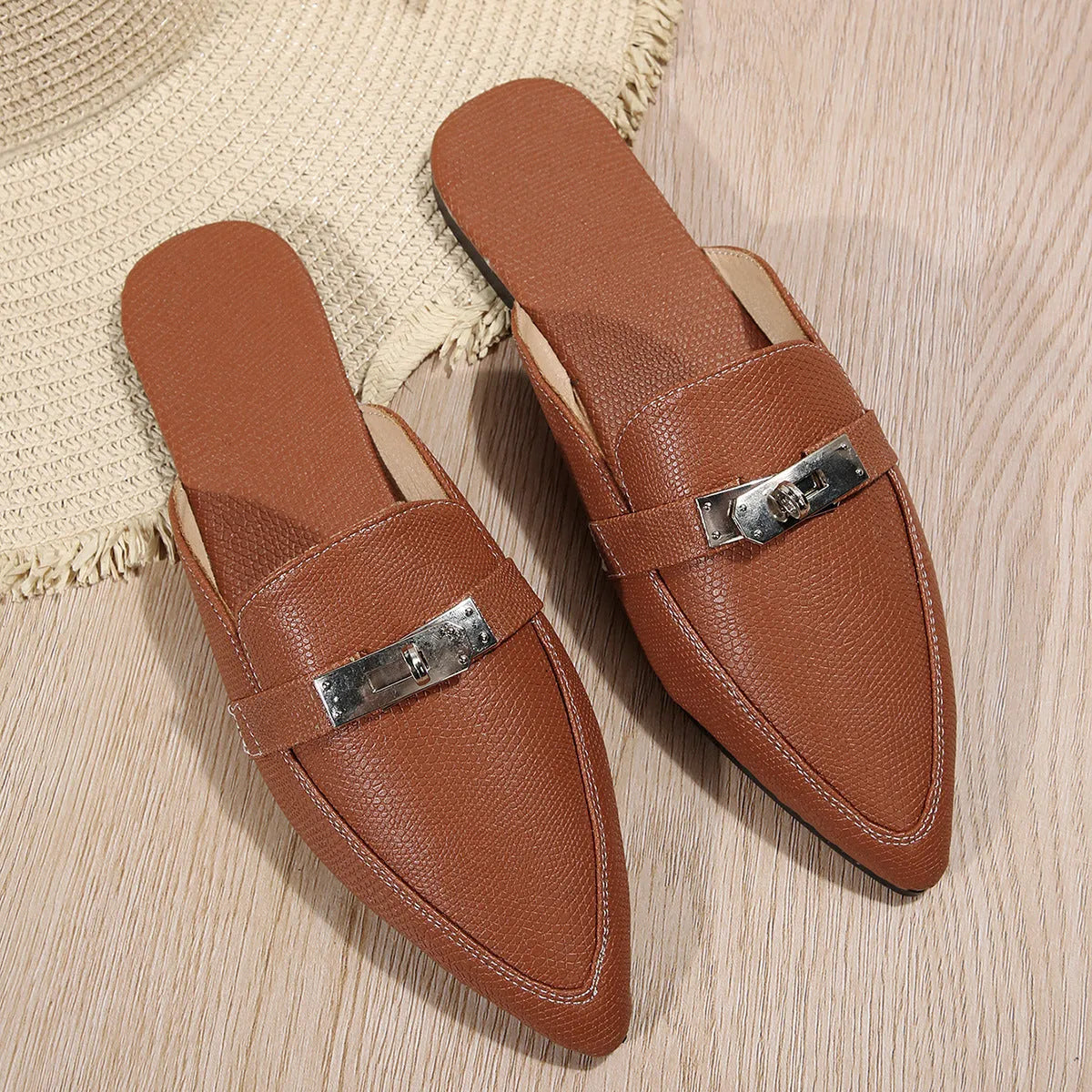 Light brown women's pointed-toe semi-slippers with a low heel and rubber sole on a white background.