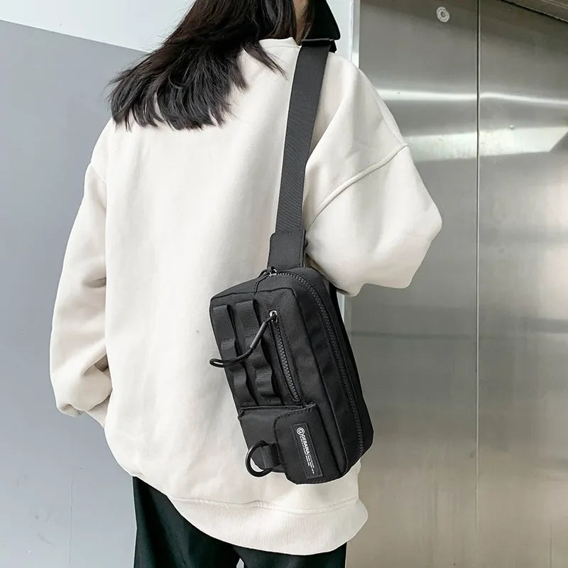 Tooling style crossbody bag in solid colour with wear-resistant nylon for outdoor sports use, below 20L capacity