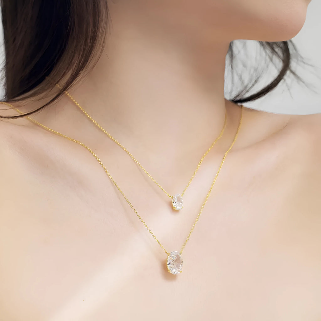 Close-up of a geometric oval ice flower pendant on an S925 sterling silver necklace, available in gold or platinum finish.
