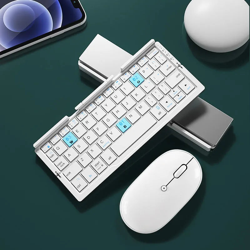 Silver white folding Bluetooth keyboard open with stand holding a smartphone, shown next to its closed compact size.