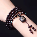 Zambia Rosewood 108-bead bracelet with flat lotus pendant on neutral background