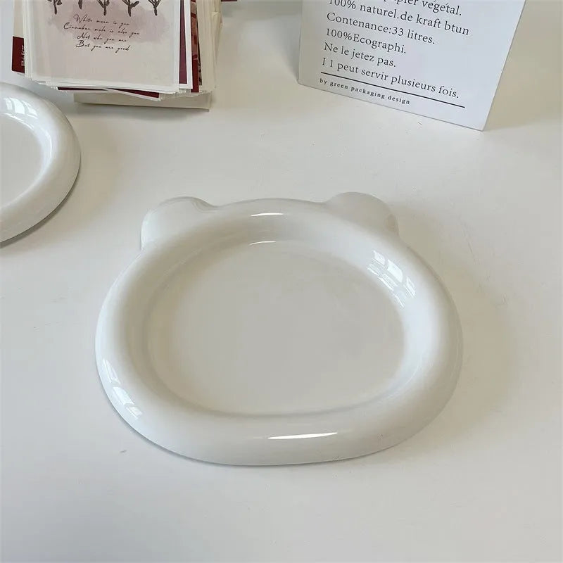 White porcelain plate with doodle design, shown in round and bear shapes, small and large sizes.