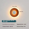 Round aluminium wall lamp in an outer white and inner gold colour combination, mounted on a wall.