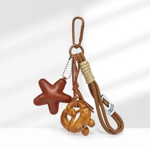 Handmade soda bread handbag pendant with baking varnish finish and brown strap attachment