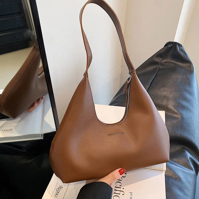 Women's retro pillow-shaped shoulder handbag in brown with sandwich pocket exterior and internal organisation
