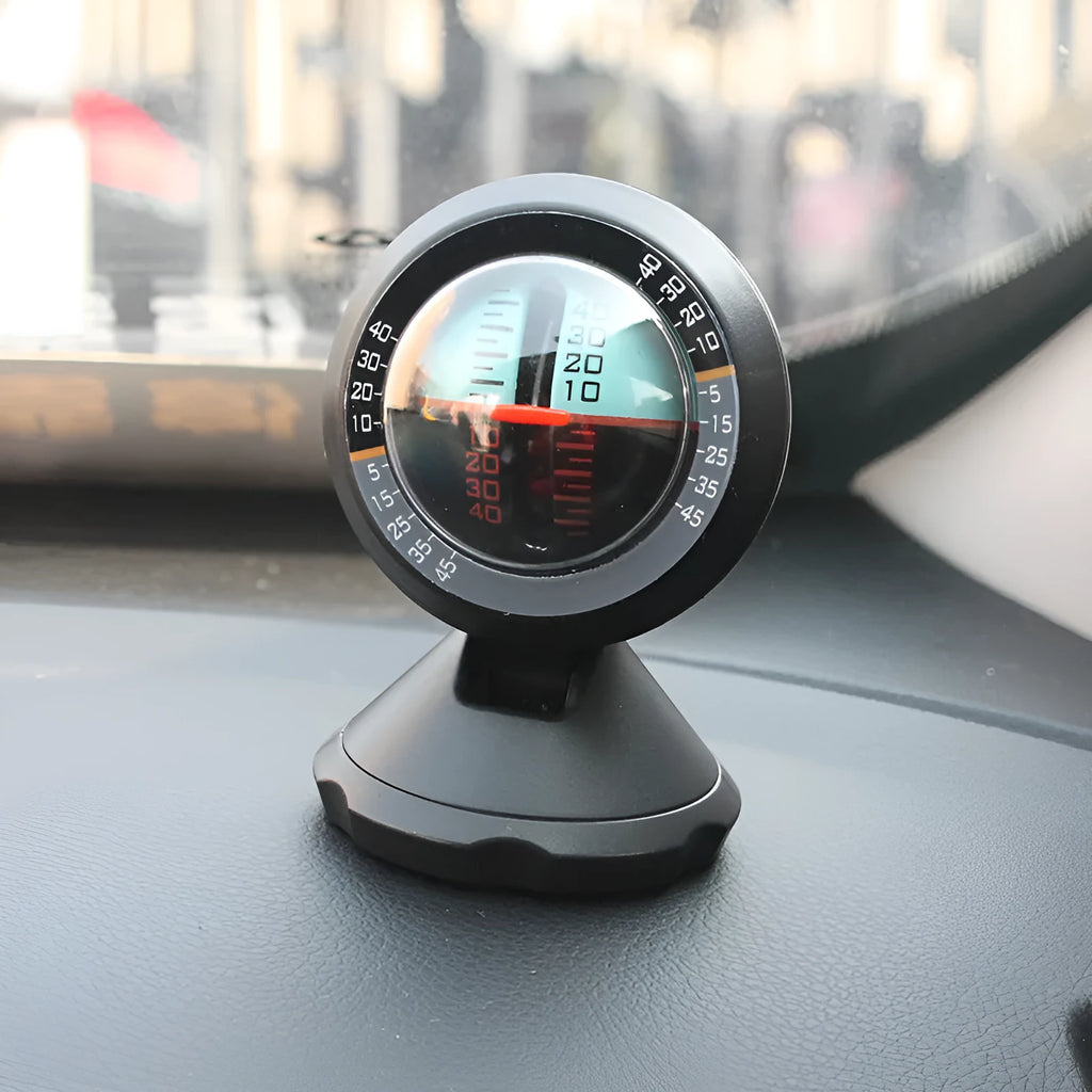 Black vehicle mounted slope meter for measuring car inclination and elevation angles on dashboard.