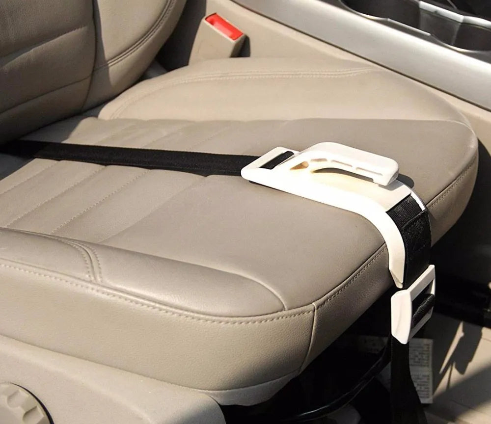 ZUWIT maternity car seat belt adjuster in white plastic attached to a seat belt, redirecting it away from the belly
