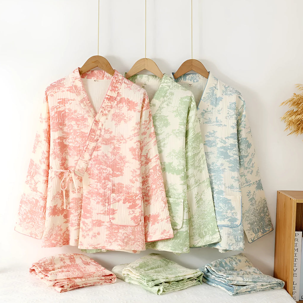 Women's pink cotton gauze lounge suit set with long sleeves and elastic waist trousers laid flat.