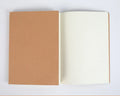 Thread-bound paper notebook with soft beige cover, open to blank pages, 16K or 32K size, multiple interior styles available