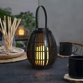 Retro oval rattan solar garden light for patio illumination with plastic construction