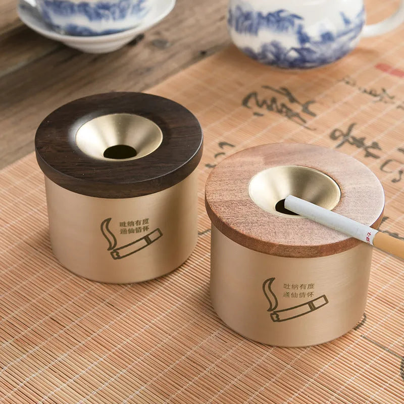 Brass ashtray with wooden lid in retro style showing middle hole design