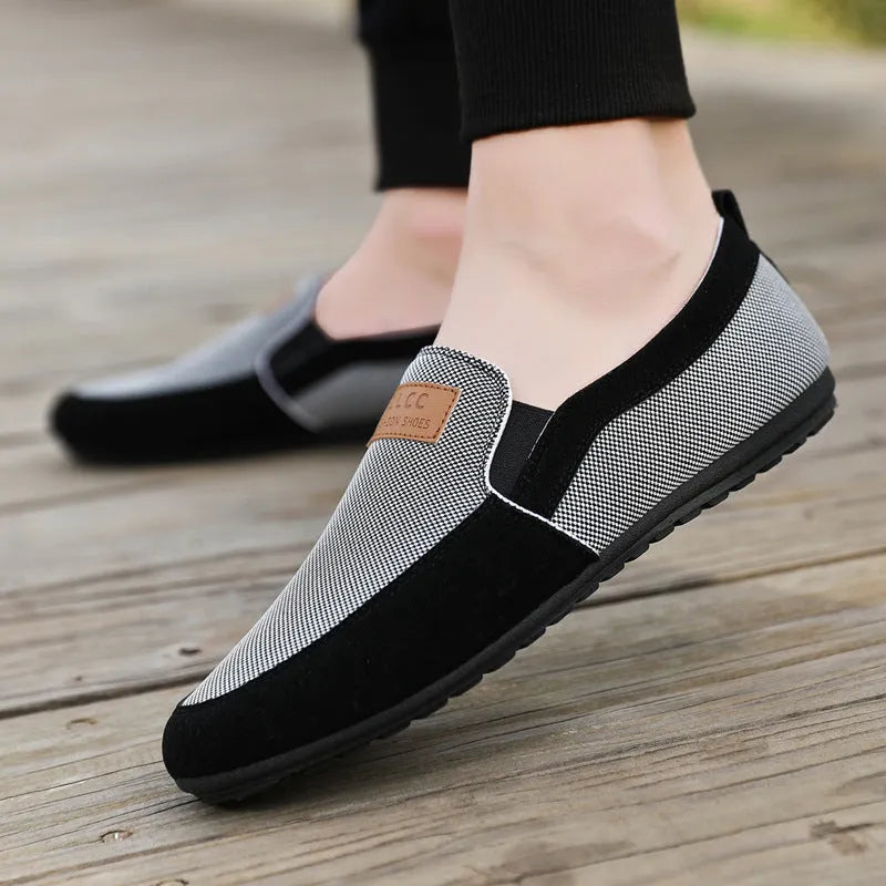 Men's grey canvas casual board shoes with round toe design and rubber soles shown from side view
