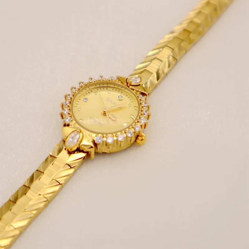 Gold quartz watch with embossed bracelet featuring 5A diamond detailing