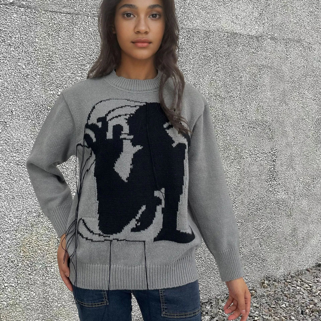 Grey loose women's alpaca wool pullover sweater with tassel detail on a hanger.