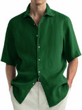 Green men's casual cotton shirt with a cardigan collar laid flat.