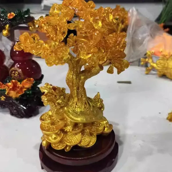 Citrine resin turtle money tree Feng Shui ornament on a white background.