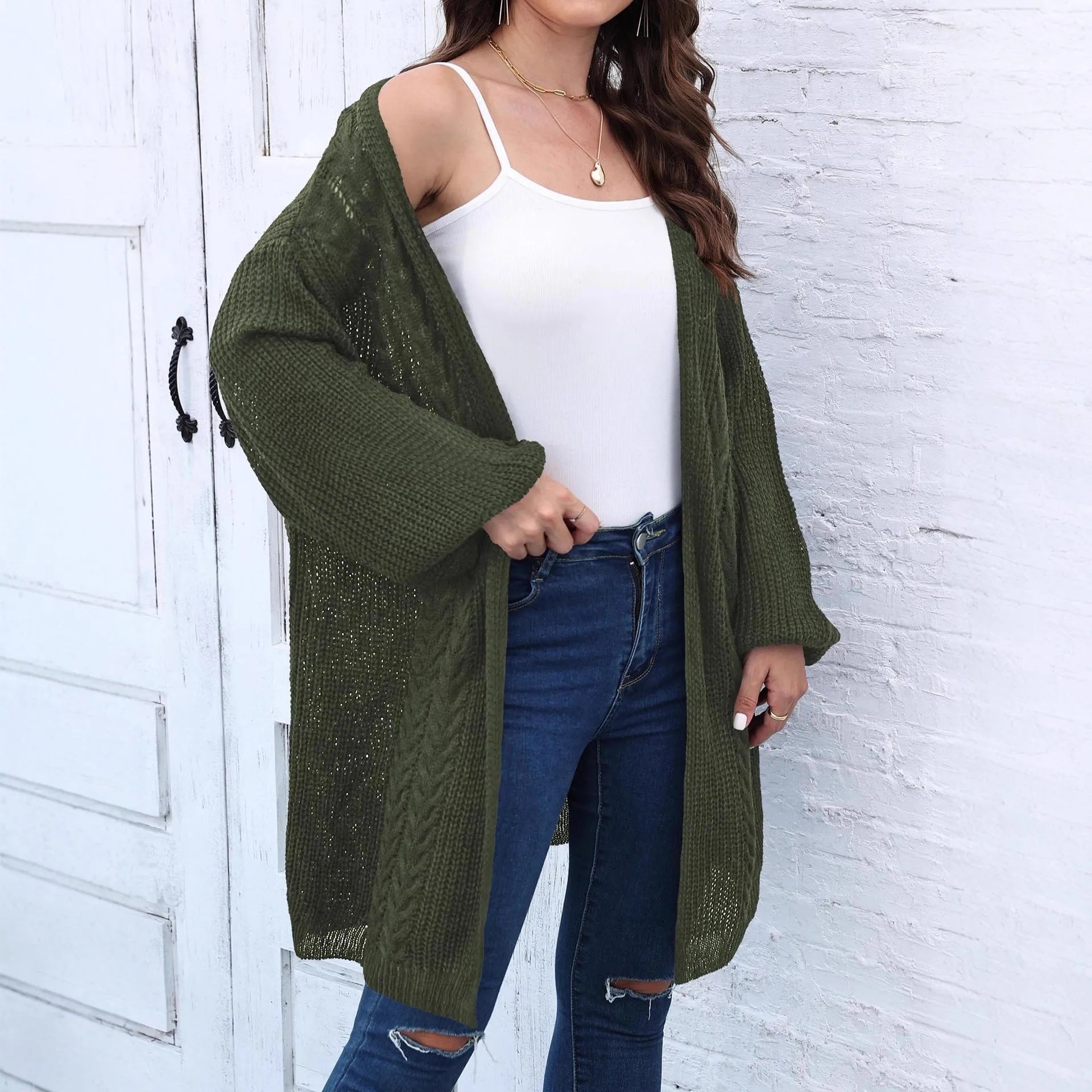 Women's loose fit acrylic sweater coat cardigan in a solid colour on a hanger.