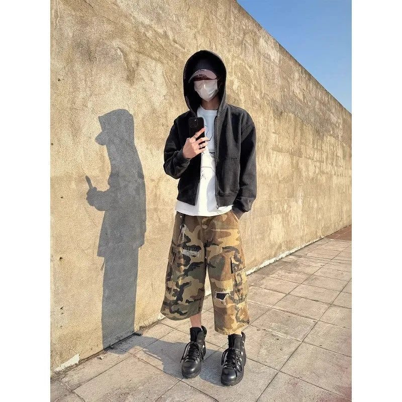 Men's camouflage cropped jeans with ripped detailing and retro patches in loose straight cut