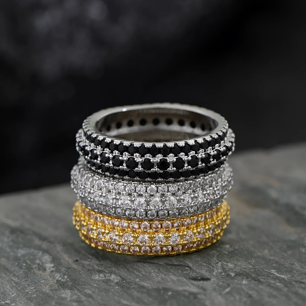 A geometric copper ring with a triangular zircon stone inlay, shown in a white gold colour finish.