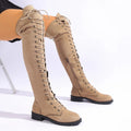 Black lace-up over-the-knee boots with round toe and flat rubber sole on a neutral background