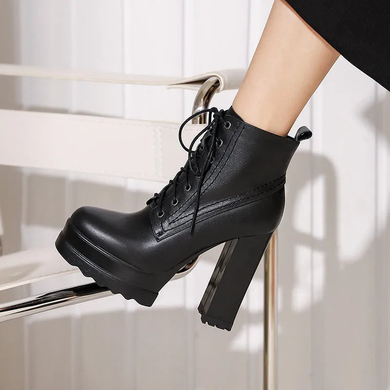 Women's black chunky heel waterproof platform ankle boots with side zip on a white background