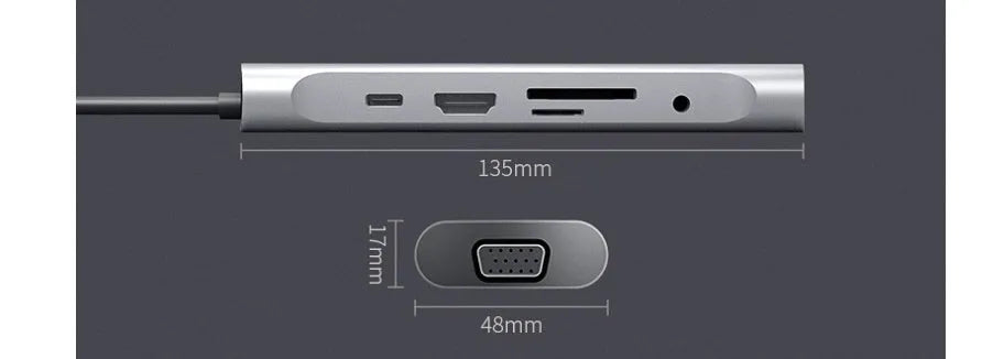 Grey aluminium USBC docking station with HDMI, VGA, USB 3.0, and charging ports on a desk.