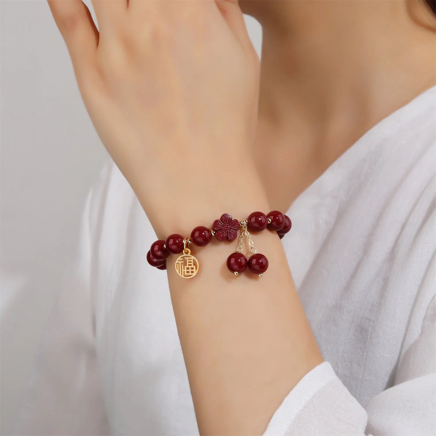Women's purple gold sand fu character bracelet with peach blossom tassel detailing and handcrafted cinnabar construction