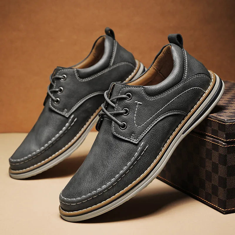 Men's black genuine leather casual lace-up shoes with round toe and low heel on a rubber sole.