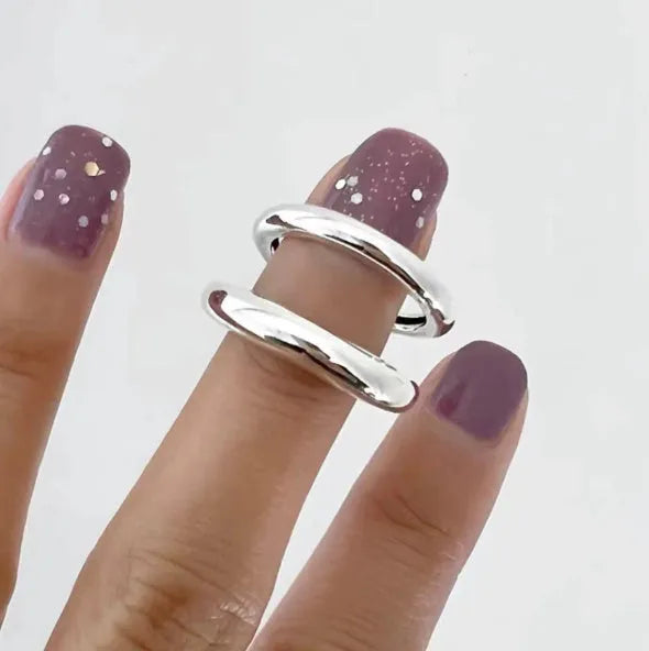 Korean-style 925 sterling silver minimalist ring for women with adjustable opening on a plain background