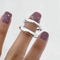 Korean-style 925 sterling silver minimalist ring for women with adjustable opening on a plain background