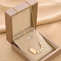 Titanium steel necklace with water wave chain and geometric mixed stone pendant in gold finish on woman