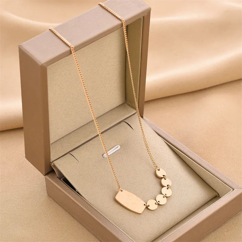 Titanium steel necklace with water wave chain and geometric mixed stone pendant in gold finish on woman