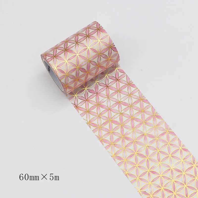 Roll of bronzing and paper decorative tape in gold colour, showing metallic finish.