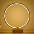 Round small solid wood and bamboo USB-powered LED night lamp on a table.
